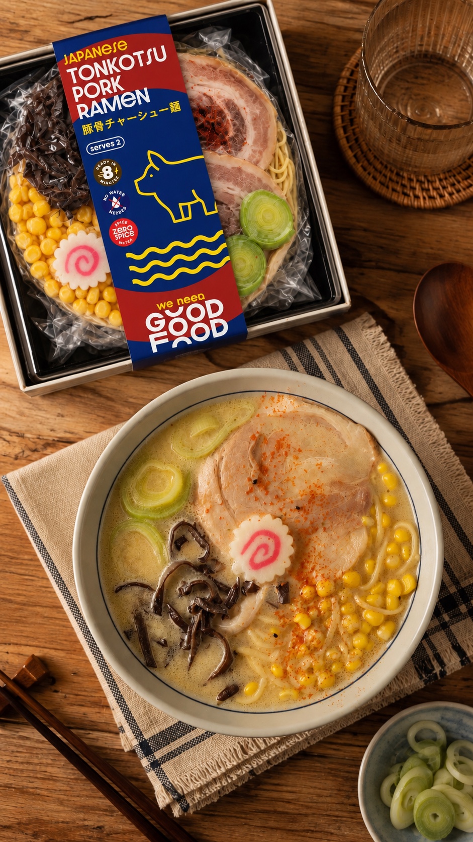 A bowl of creamy tonkotsu ramen with char siu, sweetcorn, black fungus and fish cake on a wooden table, beside the retail pack it came from.